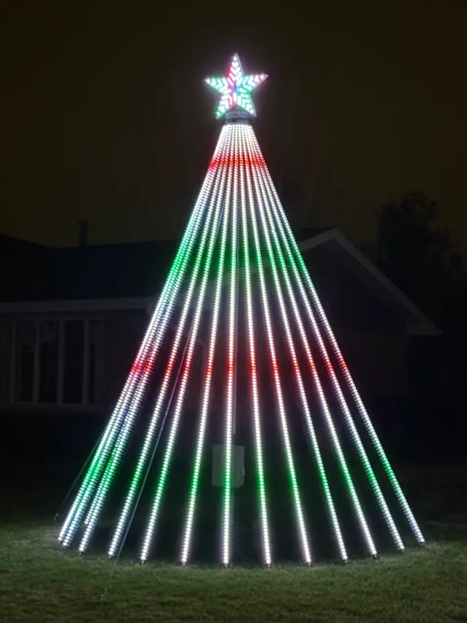 The mega tree: strands of white lights with red and green bands, and a star on top.
